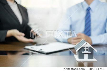 Real estate agents offer sale home insurance and close the sale immediately after the customer signs a purchase contract under a formal agreement. Real Estate Home insurance concept 105873746
