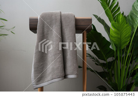 Gray terry towels in the bathroom near the green toilet Gray terry towels in the bathroom near the green toilet 105875443