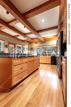 Kitchen interior in a wooden house with high ceilings and beams. Kitchen interior in a wooden house with high ceilings and beams. 105875446