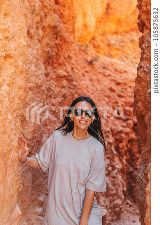 Hiker woman in beautiful nature landscape with hoodoos, pinnacles and spires rock formations. Bryce Canyon National Park in Utah, United States.  105875632