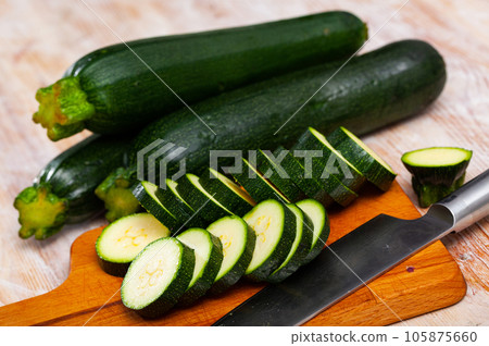 Sliced zucchini on wooden table 105875660