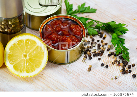 Image of pickled squids in American Salsa sauce in open tin can 105875674
