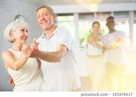 Elderly woman and man dancing Viennese waltz in dance class 105876017