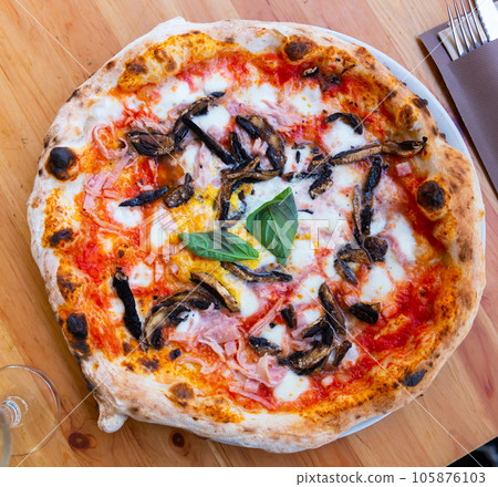 Freshly baked homemade pizza with eggplant and ham Freshly baked homemade pizza with eggplant and ham 105876103