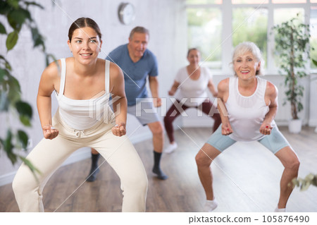 Portrait of active mature women enjoying modern energetic dancing in a group in studio Portrait of active mature women enjoying modern energetic dancing in a group in studio 105876490