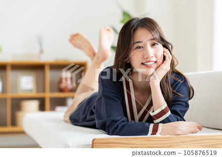 Young woman relaxing in the living room Young woman relaxing in the living room 105876519