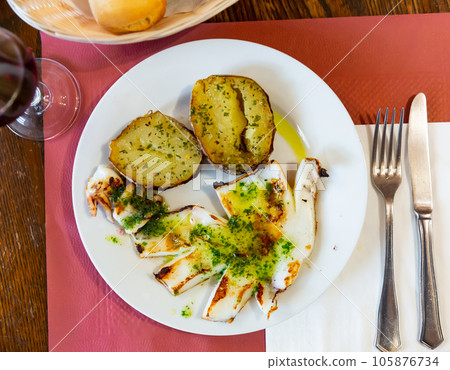 Grilled cuttlefish served with garlic and parsley Grilled cuttlefish served with garlic and parsley 105876734
