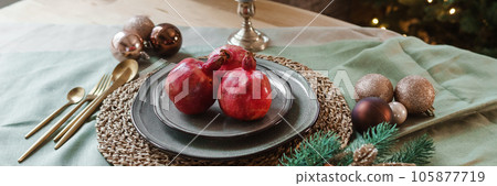 Serving a festive Christmas table in Scandinavian style. Decor on the table before the holiday. 105877719