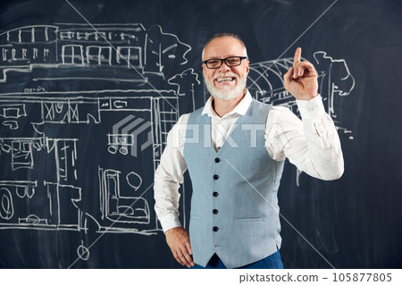 Happy and excited bearded senior man, architect raising finger up, expressing new creative architectural ideas Happy and excited bearded senior man, architect raising finger up, expressing new creative architectural ideas 105877805
