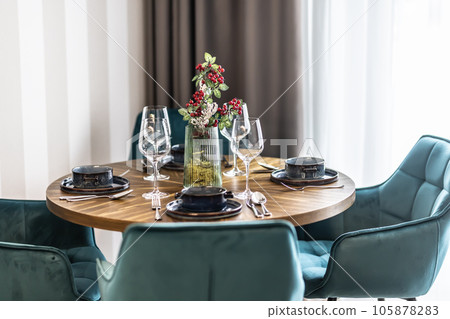 Dining room with wooden table and blue chairs floor in modern apartment Dining room with wooden table and blue chairs floor in modern apartment 105878283