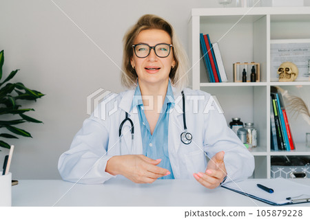 Headshot of middle aged female doctor talking with client online on computer, female nurse talking to sick patient on video call, using laptop. Telemedicine concept. Online remote medical appointment 105879228