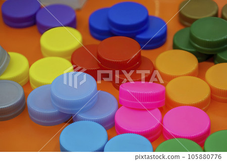 The pile of multi color plastic caps of drinking water bottles. The pile of multi color plastic caps of drinking water bottles. 105880776