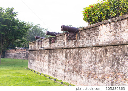 Old cannon on red brick wall is important historical site. Fort Cornwallis in Georgetown, Penang, Star fort built by British East India Company in late 18th century. Largest standing fort in Malaysia. Old cannon on red brick wall is important historical site. Fort Cornwallis in Georgetown, Penang, Star fort built by British East India Company in late 18th century. Largest standing fort in Malaysia. 105880863