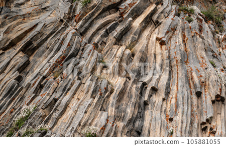 natural stone background texture. Basalt columns, rock formation, unusual mountain topography, geological background natural stone background texture. Basalt columns, rock formation, unusual mountain topography, geological background 105881055