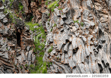 natural stone background texture. rock formation, unusual mountain topography, geological backdrop. Basalt columns formation natural stone background texture. rock formation, unusual mountain topography, geological backdrop. Basalt columns formation 105881059