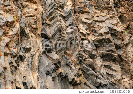 natural stone background texture. rock formation, unusual mountain topography, geological backdrop. Basalt columns formation natural stone background texture. rock formation, unusual mountain topography, geological backdrop. Basalt columns formation 105881066