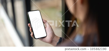 Female using smartphone blank screen display frameless. Gadget mockup design 105882190