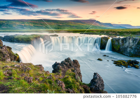 Godafoss waterfall flowing with colorful sunset sky in summer at Iceland 105882776
