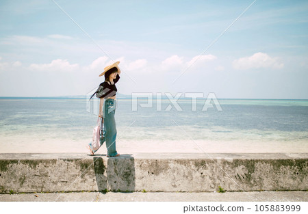 Travel to Okinawa A woman strolling along the beach 105883999