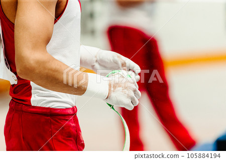 hands male gymnast in wrist wraps and gym chalk hands male gymnast in wrist wraps and gym chalk 105884194