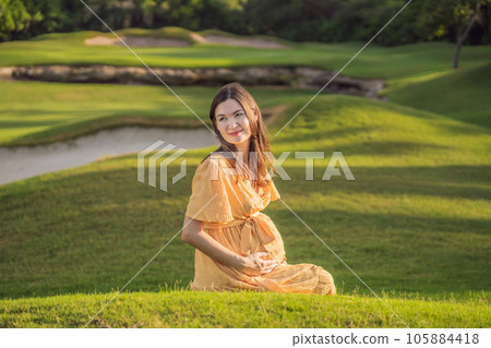 A serene and radiant pregnant woman after 40, surrounded by nature's beauty in the park, cherishing the journey of motherhood with a glowing smile A serene and radiant pregnant woman after 40, surrounded by nature's beauty in the park, cherishing the journey of motherhood with a glowing smile 105884418