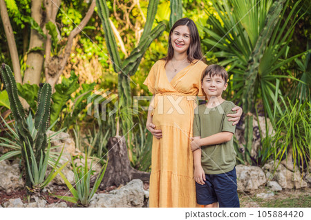 A heartwarming moment captured in the park as a pregnant woman after 40 shares a special bond with her teenage son, embracing the beauty of mother-daughter connection 105884420