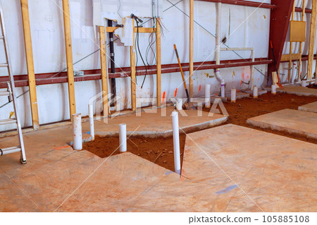 Lavatory restroom planning concrete floor exposes drainage pvc pipe endings for a plumbing 105885108