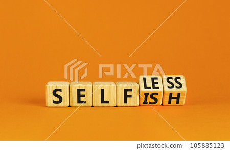 Selfish or selfless symbol. Psychologist turns cubes and changes the word selfish to selfless. Beautiful orange background, copy space. Business, psychological and selfish or selfless concept. 105885123