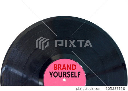 Brand yourself symbol. Concept words Brand yourself on beautiful black purple vynil disk. Beautiful white table white background. Business brand yourself concept. Copy space. Brand yourself symbol. Concept words Brand yourself on beautiful black purple vynil disk. Beautiful white table white background. Business brand yourself concept. Copy space. 105885138