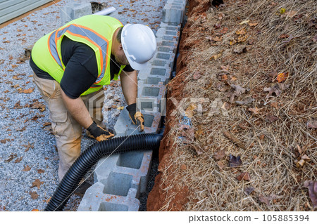 Construction team is currently working on laying drainage pipe for rainwater in retaining wall. Construction team is currently working on laying drainage pipe for rainwater in retaining wall. 105885394