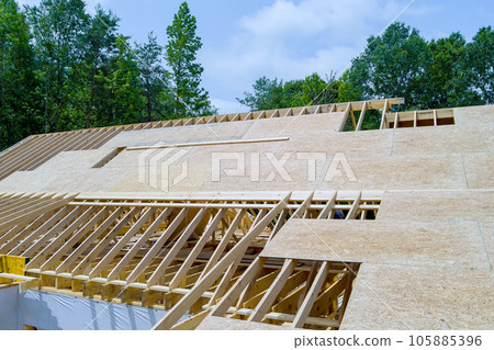 On roof plywood of wooden built home that is under construction, there in construction site 105885396