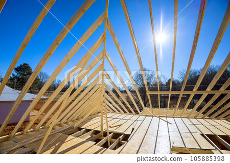 Support beams beams roof construction at new house construction using wood frame truss Support beams beams roof construction at new house construction using wood frame truss 105885398