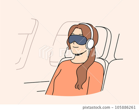 Young woman passenger flight with blindfold and earphones sleeps in airplane chair 105886261