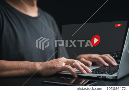 Man engrossed in watching a live stream on the internet. Online video streaming window on the computer screen. Embrace the digital era of entertainment and information. 105886472