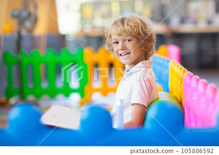 Little boy in with toys in school classroom. Little boy in with toys in school classroom. 105886592