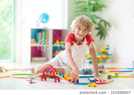 Child with toy train. Kids wooden railway. 105886607