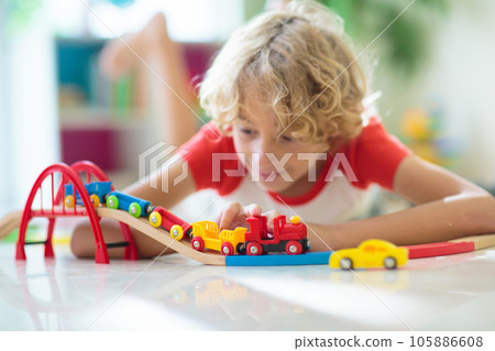 Child with toy train. Kids wooden railway. 105886608
