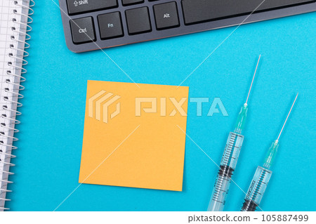 Vaccination or Revaccination Concept - Two Medical Syringe on Blue Table 105887499