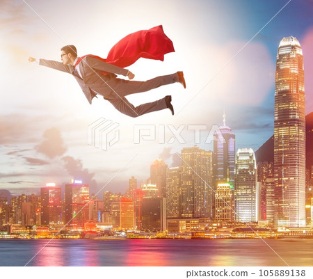 Superhero businessman flying over the city 105889138