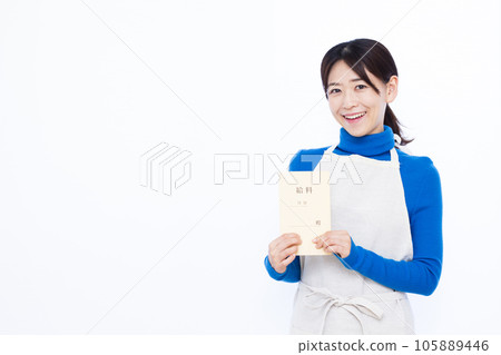 A smiling 30s housewife holding a pay bag in front of a white background A smiling 30s housewife holding a pay bag in front of a white background 105889446