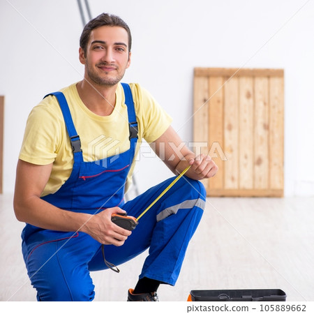 Young male contractor working indoors 105889662