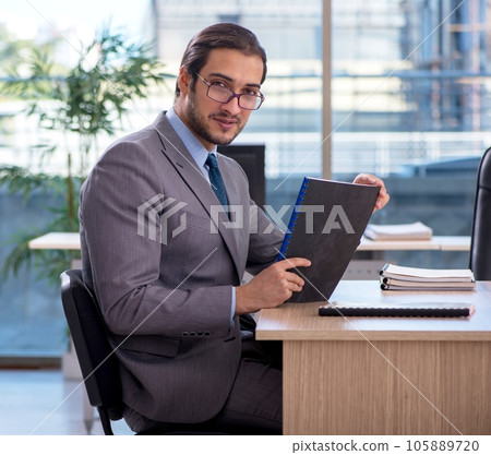Young male employee working in the office Young male employee working in the office 105889720