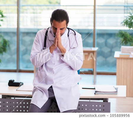 Young male medic working in the clinic 105889956