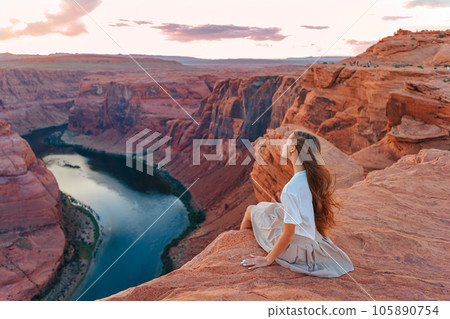 Happy girl on the edge of the cliff at Horseshoe Band Canyon in Page, Arizona. Adventure and tourism concept. Beautiful nature in USA 105890754