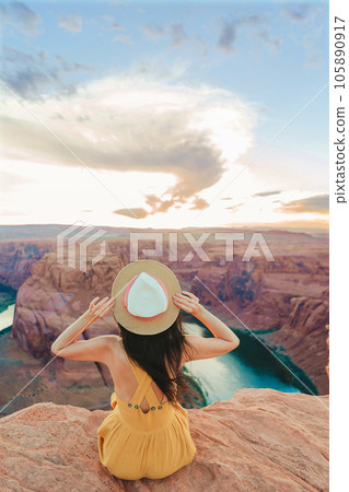 Beautiful woman in yellow dress on the edge of the cliff at Horseshoe Band Canyon in Paje, Arizona. Beautiful nature in USA 105890917