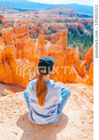 Hiker girl in Bryce Canyon hiking relaxing looking at amazing view during hike on summer travel in Bryce Canyon National Park, Utah, United States. 105891022