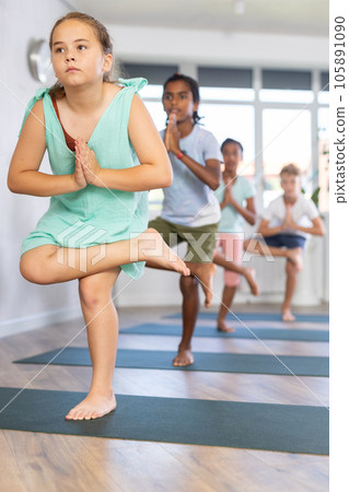Kids yoga half lotus tree pose. Kids yoga half lotus tree pose. 105891090