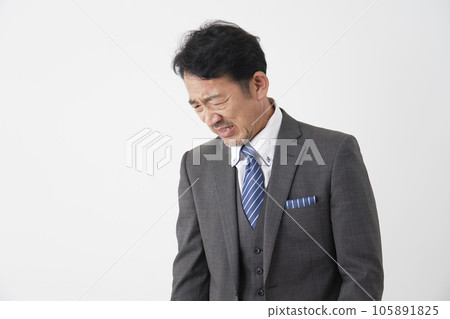 A depressed middle-aged businessman White background A depressed middle-aged businessman White background 105891825