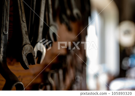 Set of wrenches mounted on a wall in a workshop.  105893320