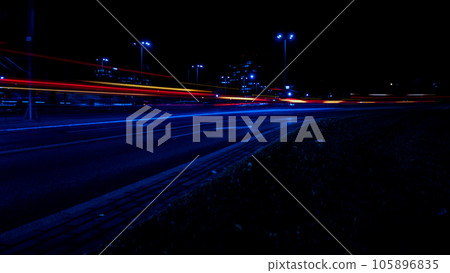 Lights of cars at night. Street line lights. Night highway city. Long exposure photograph night road. Colored bands of red light trails on the road. Background wallpaper defocused Lights of cars at night. Street line lights. Night highway city. Long exposure photograph night road. Colored bands of red light trails on the road. Background wallpaper defocused 105896835
